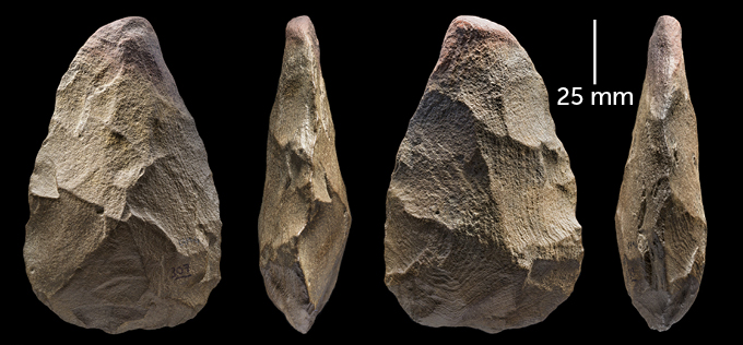a stone hand axe shown from four different angles